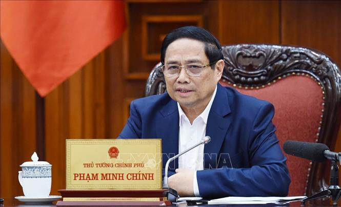 Thủ tướng Phạm Minh Chính chủ trì cuộc họp với ngành ngân hàng về chính sách tiền tệ. Ảnh: Dương Giang/TTXVN Chú thích ảnh