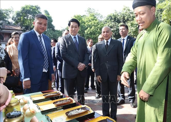 Chủ tịch nước Lương Cường và Quốc vương Campuchia Norodom Sihamoni nghe giới thiệu về trà quí của Việt Nam. Ảnh: Lâm Khánh/TTXVN