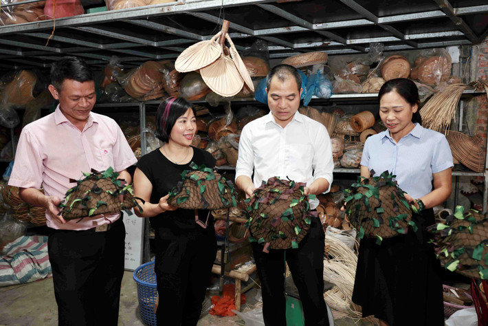 Bài cuối: Góp sức lan tỏa thương hiệu làng nghề ảnh 1 Chị Nguyễn Thị Hân (áo đen) tự hào giới thiệu Chiếc mũ Điện Biên với lãnh đạo xã Phú Vinh, NHCSXH và Hội Phụ nữ. Ảnh: Đức Kiên