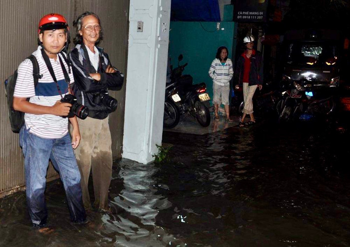 Khi ông Nghĩa đi tác nghiệp, kể cả lúc nửa đêm luôn có người vợ (áo trắng phía sau) đồng hành, chia sẻ và trở thành người giữ xe bất đắc dĩ Vào nghề báo đầy nhiệt huyết và ngày trở về thảnh thơi của “bố Nghĩa”