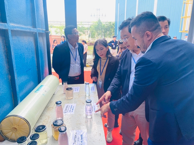Cục trưởng Phạm Hồng Quất cùng các đại biểu xem sản phẩm mẫu nước sau khi đã được xử lý Ký kết chuyển giao công nghệ xử lý nước nano -0